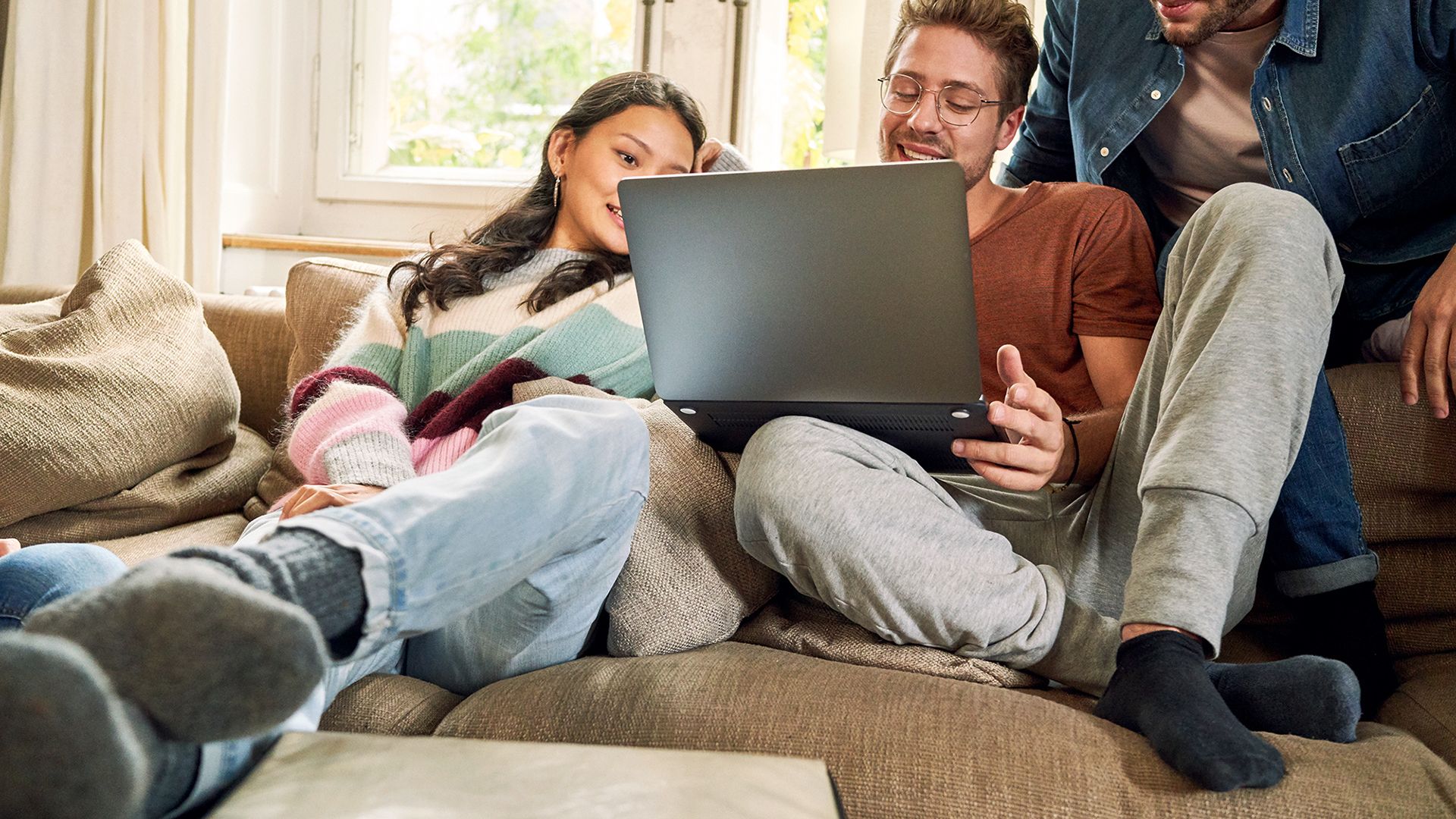 L'image montre des personnes travaillant sur un ordinateur portable.